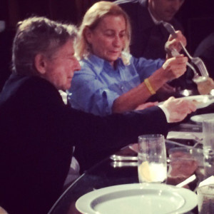 Miuccia serves dinner to film director Roman Polanski